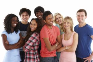 Group of diverse teenagers standing together and smiling for the camera. Horizontal shot.